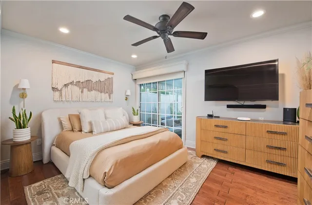 a bedroom with a large bed and a flat screen tv