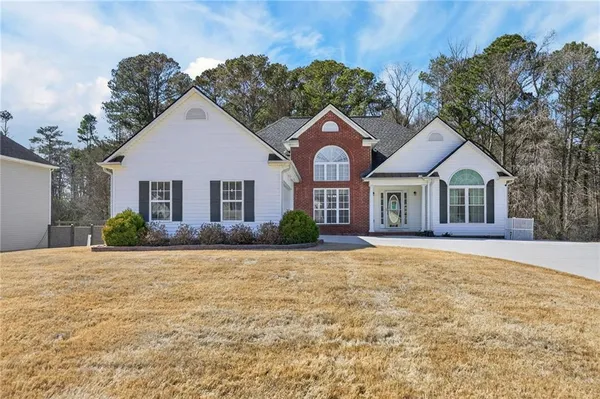 a front view of a house with a yard