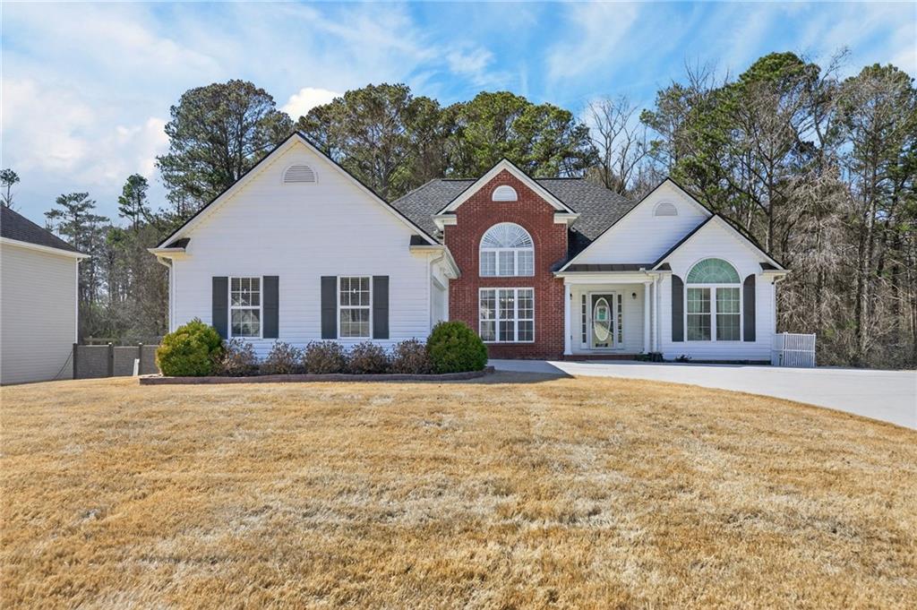 a front view of a house with a yard
