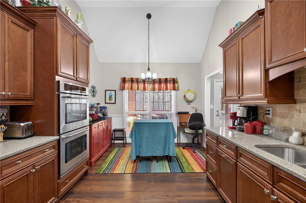 143 Autumn Run Place Villa Rica, GA 30180 - Photo 11 of 30 a kitchen with granite countertop stainless steel appliances a stove refrigerator and cabinets