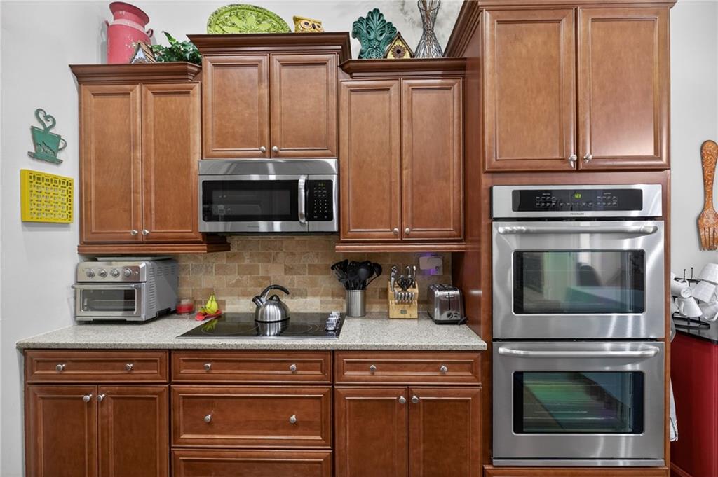 143 Autumn Run Place Villa Rica, GA 30180 - Photo 12 of 30 a kitchen with stainless steel appliances granite countertop a stove microwave and cabinets
