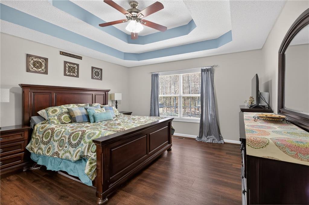 143 Autumn Run Place Villa Rica, GA 30180 - Photo 13 of 30 a living room with a bed furniture and a flat screen tv