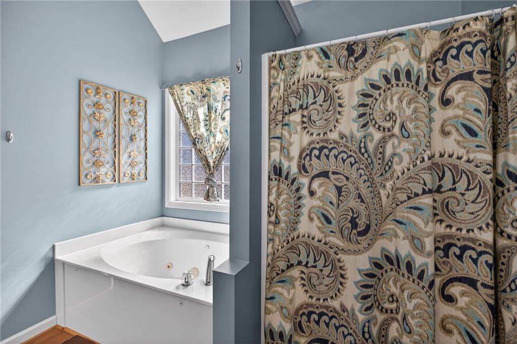 143 Autumn Run Place Villa Rica, GA 30180 - Photo 17 of 30 a bathroom with a bathtub and shower