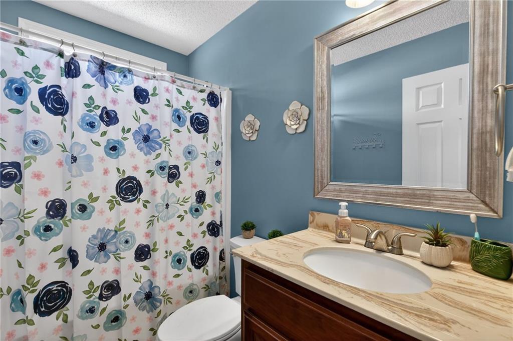 143 Autumn Run Place Villa Rica, GA 30180 - Photo 18 of 30 a bathroom with a sink and a mirror
