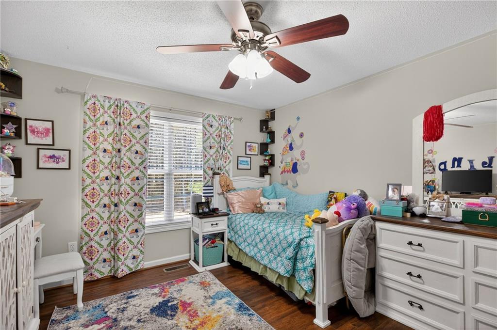143 Autumn Run Place Villa Rica, GA 30180 - Photo 19 of 30 a bedroom with a bed and a chandelier