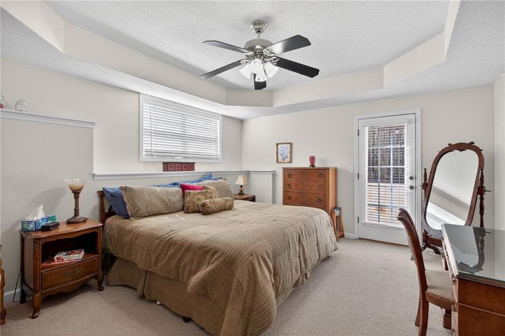 143 Autumn Run Place Villa Rica, GA 30180 - Photo 21 of 30 a bedroom with a bed and a chandelier