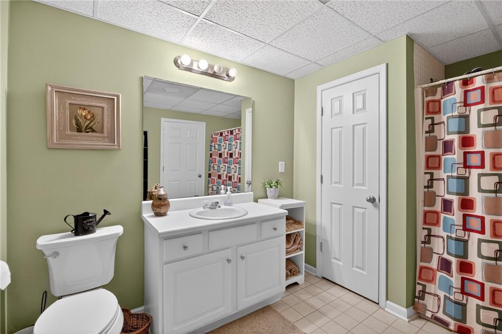 143 Autumn Run Place Villa Rica, GA 30180 - Photo 22 of 30 a bathroom with a toilet sink and mirror