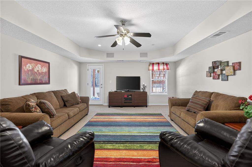 143 Autumn Run Place Villa Rica, GA 30180 - Photo 4 of 30 a living room with furniture and a flat screen tv