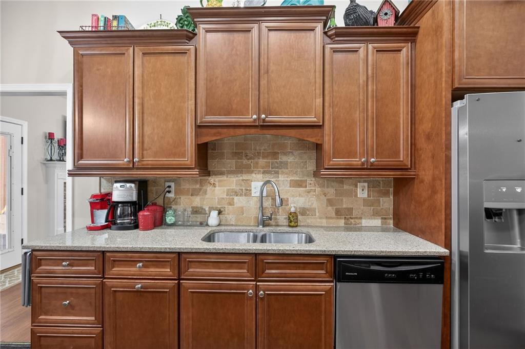 143 Autumn Run Place Villa Rica, GA 30180 - Photo 10 of 30 a kitchen with stainless steel appliances granite countertop a sink and cabinets