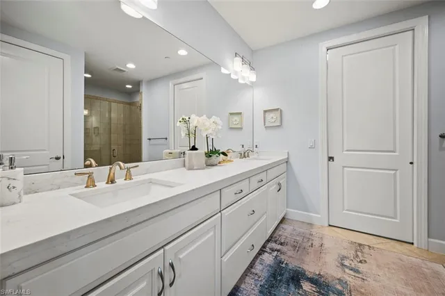 a bathroom with double vanity sinks and a mirror