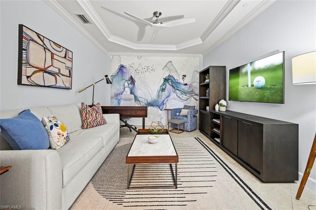 8777 Bellano Court, Unit 101 Naples, FL 34119 - Photo 14 of 39 a living room with furniture and a flat screen tv