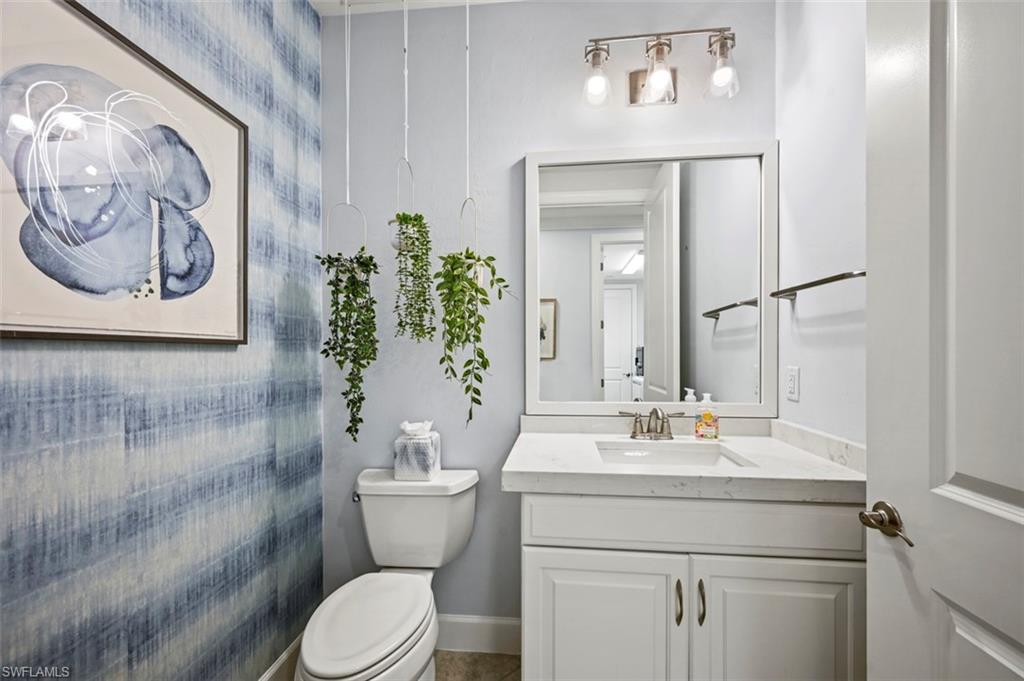8777 Bellano Court, Unit 101 Naples, FL 34119 - Photo 15 of 39 a bathroom with a toilet sink and mirror
