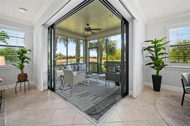 a living room with patio furniture and a potted plant