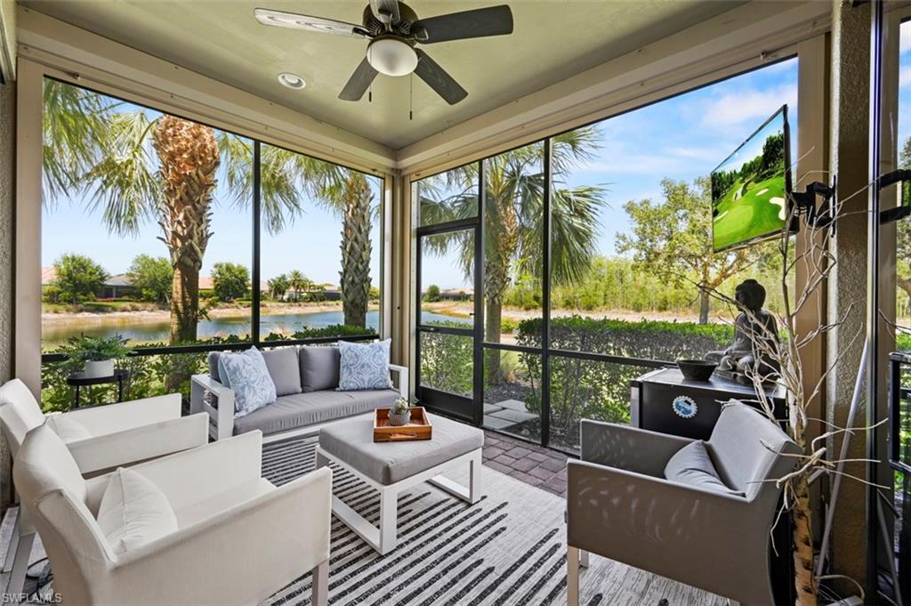 8777 Bellano Court, Unit 101 Naples, FL 34119 - Photo 19 of 39 a living room with patio furniture and a floor to ceiling window