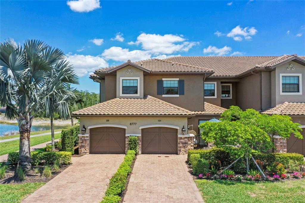 8777 Bellano Court, Unit 101 Naples, FL 34119 - Photo 22 of 39 a front view of a house with yard