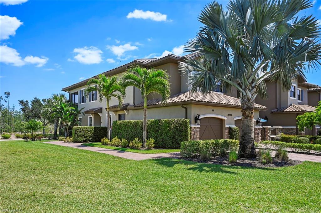 8777 Bellano Court, Unit 101 Naples, FL 34119 - Photo 23 of 39 a front view of a house with garden
