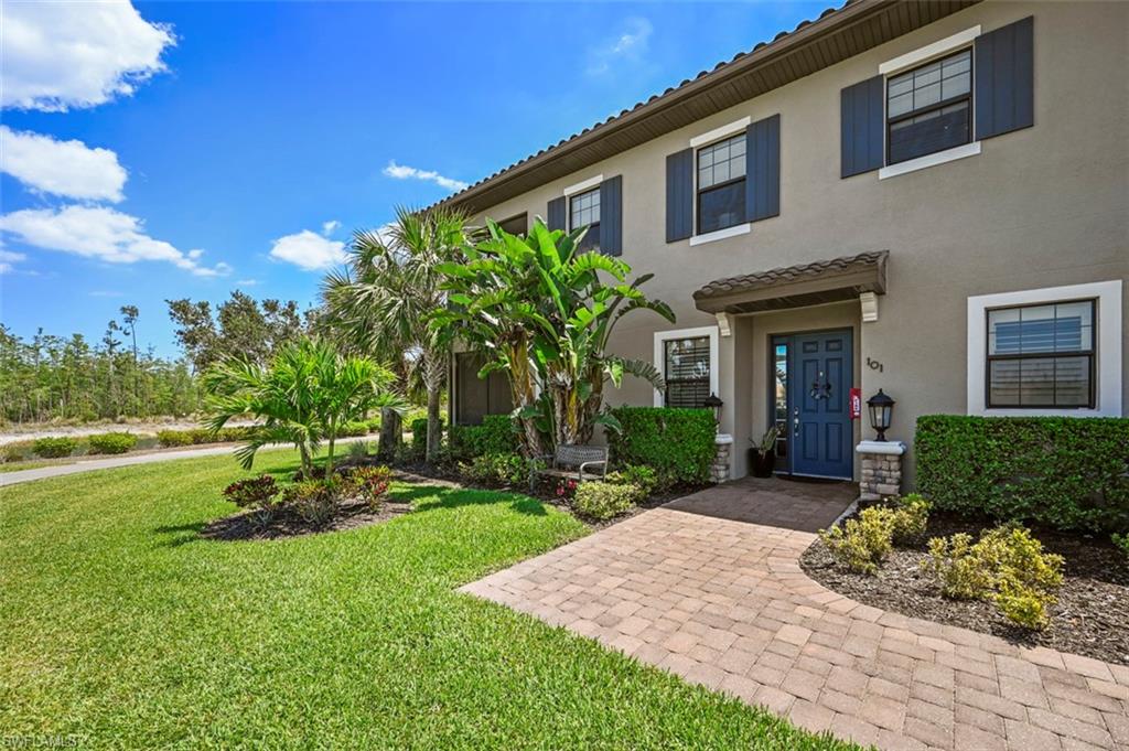 8777 Bellano Court, Unit 101 Naples, FL 34119 - Photo 24 of 39 a front view of a house with garden
