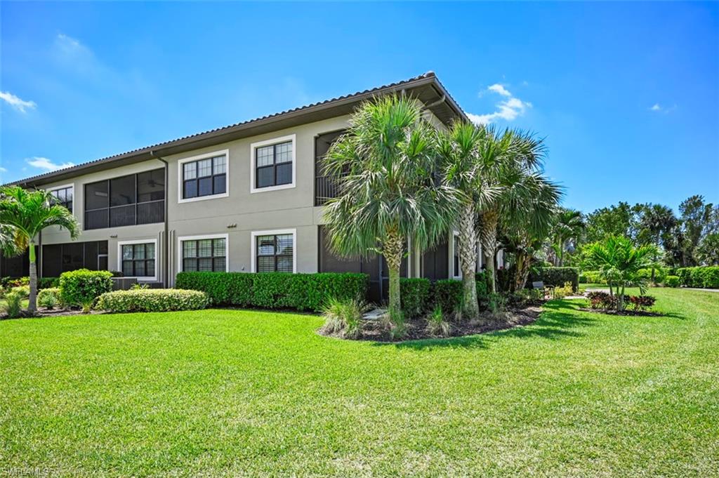 8777 Bellano Court, Unit 101 Naples, FL 34119 - Photo 29 of 39 a view of a house with a yard