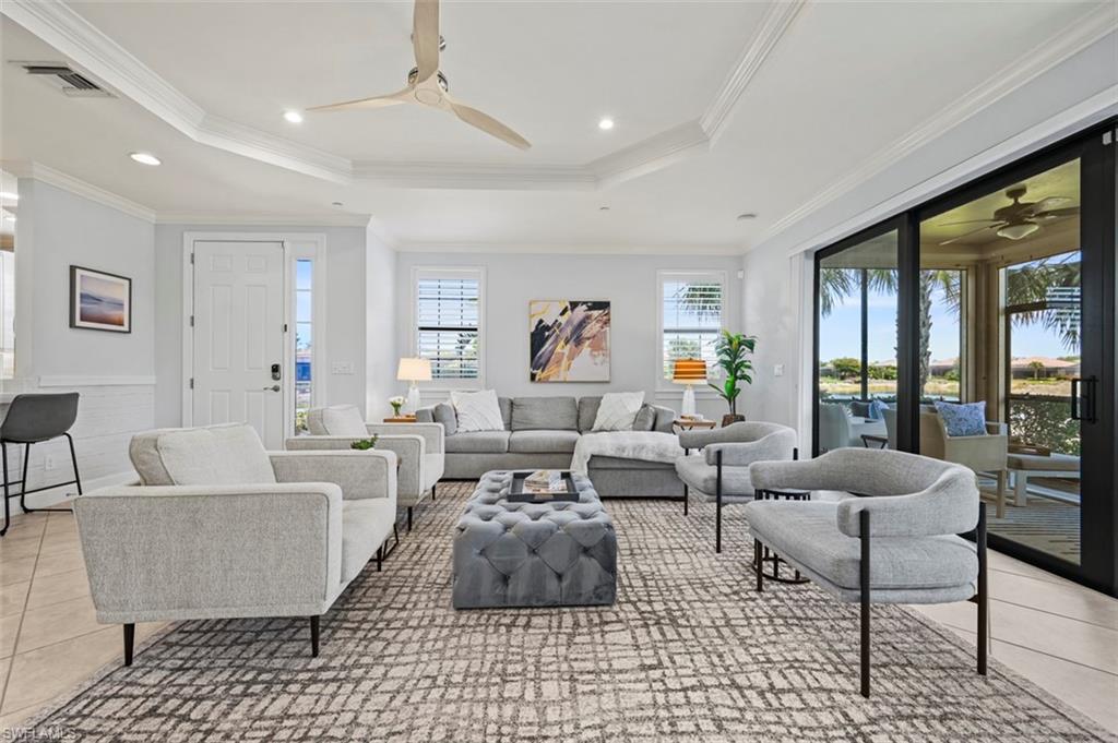 8777 Bellano Court, Unit 101 Naples, FL 34119 - Photo 3 of 39 a living room with furniture and a large window