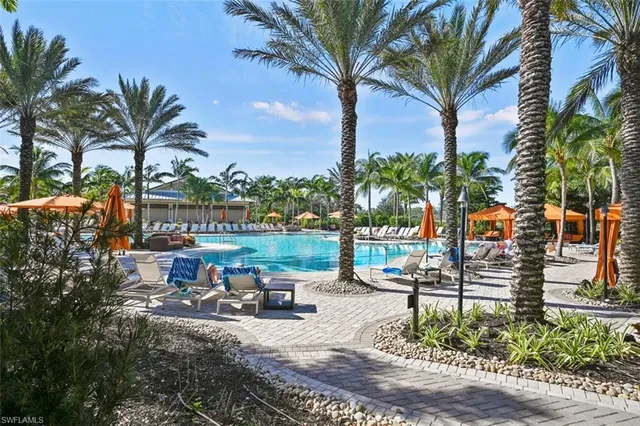 a view of a palm tree with table and chairs in patio