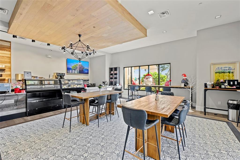 8777 Bellano Court, Unit 101 Naples, FL 34119 - Photo 35 of 39 a view of a dining room with furniture