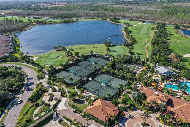 an aerial view of a houses with outdoor space and parking
