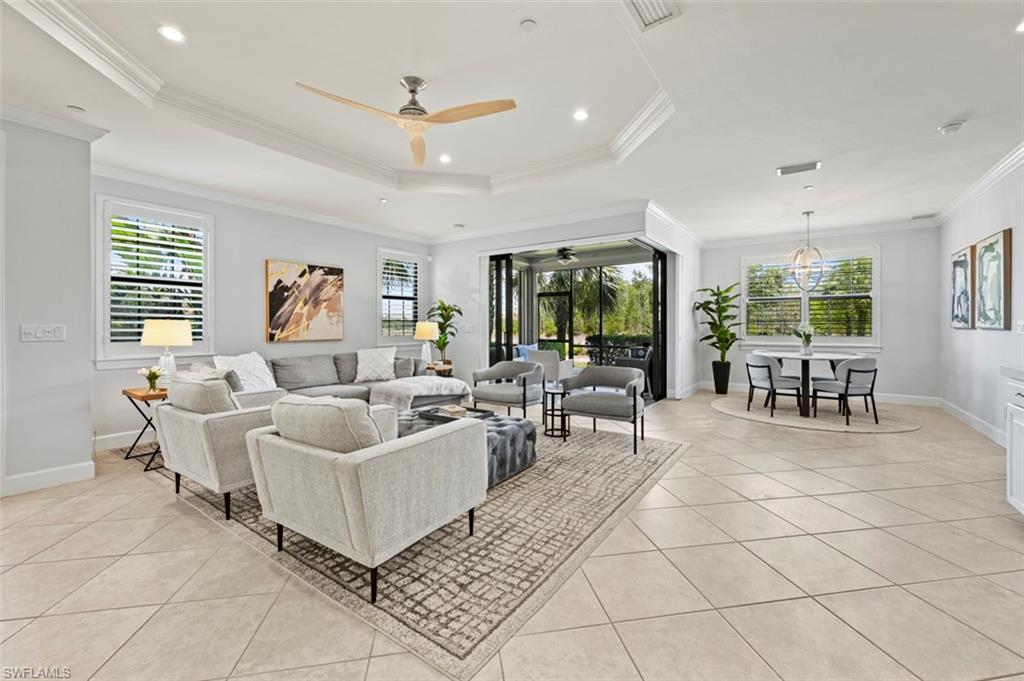 8777 Bellano Court, Unit 101 Naples, FL 34119 - Photo 7 of 39 a living room with furniture and a large window
