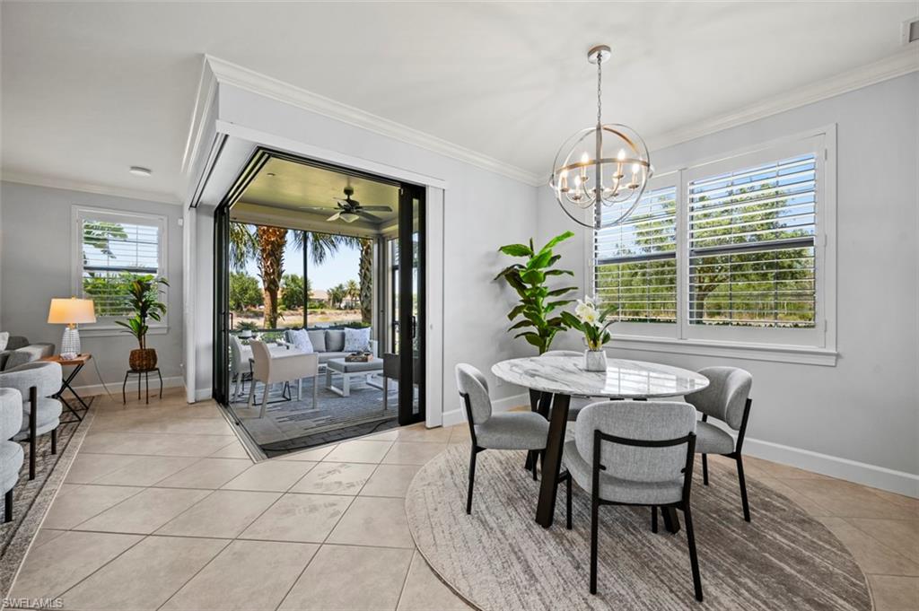 8777 Bellano Court, Unit 101 Naples, FL 34119 - Photo 8 of 39 a view of a dining room with furniture window and wooden floor