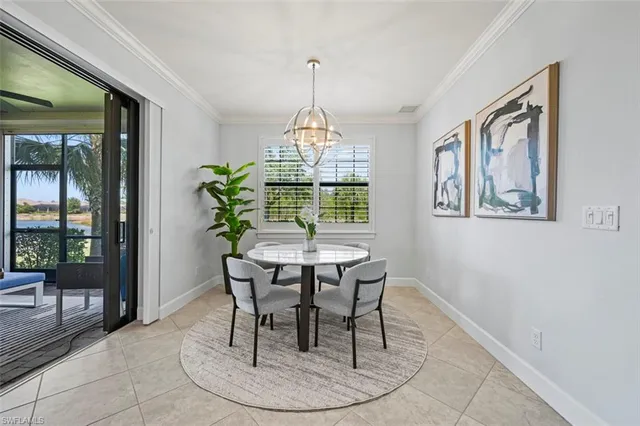a dining room with furniture a chandelier and wooden floor