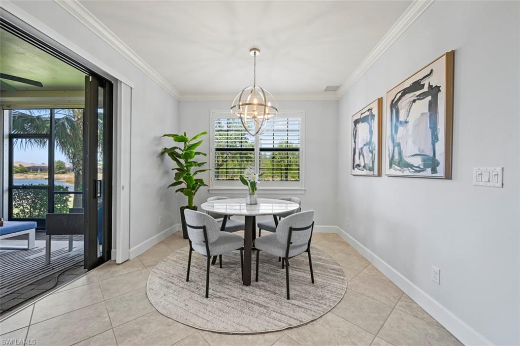 8777 Bellano Court, Unit 101 Naples, FL 34119 - Photo 9 of 39 a dining room with furniture a chandelier and wooden floor
