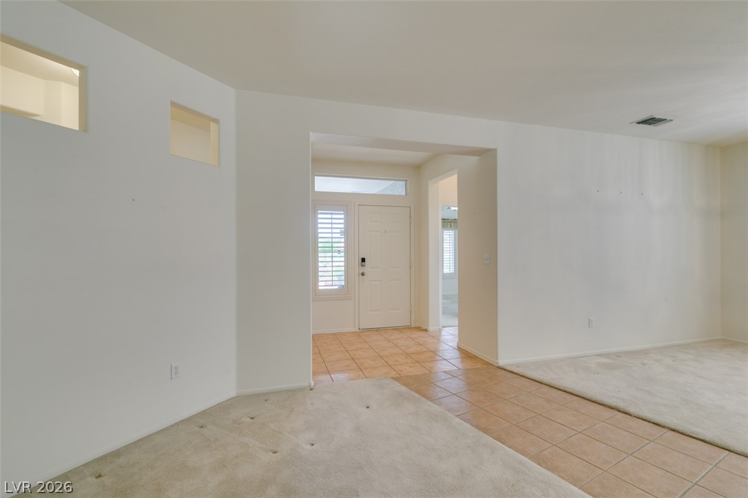 2189 Chapman Ranch Drive Henderson, NV 89012 - Photo 8 of 60 An inviting entryway leads directly into light-filled living spaces featuring a mixture of tile and carpeting.