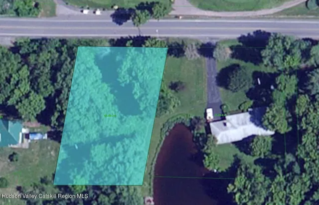 a view of a field with trees in the background