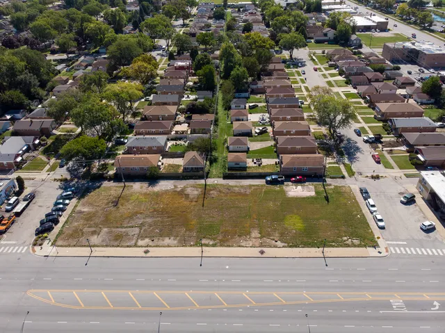 an aerial view of a residential houses with yard