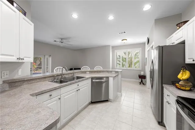 a kitchen with a sink appliances and cabinets