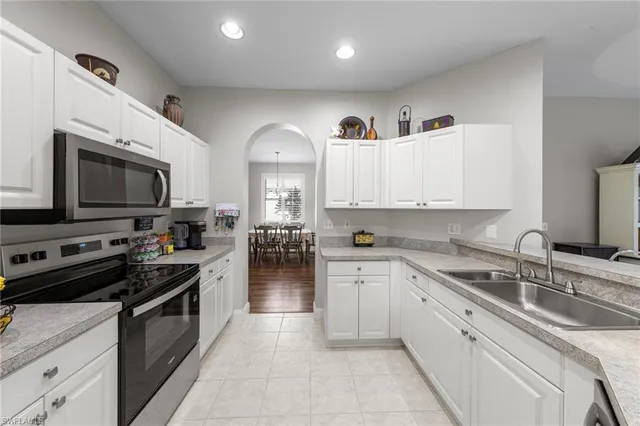 a kitchen with a sink stove and microwave