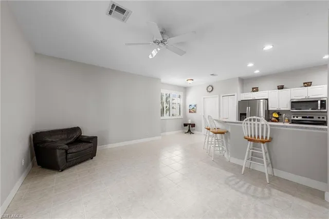 a living room with furniture and a kitchen