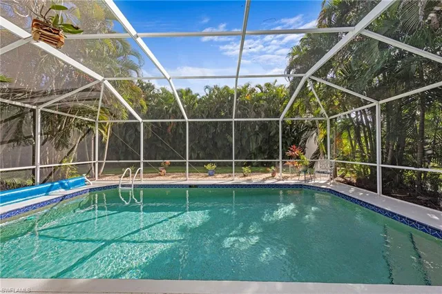 a view of a backyard with swimming pool