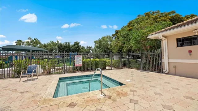 a view of a swimming pool with a patio and a garden