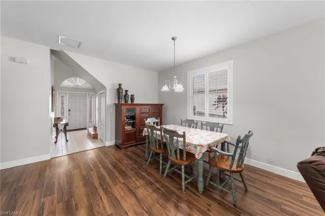 a view of a a dining room with furniture window and wooden floor