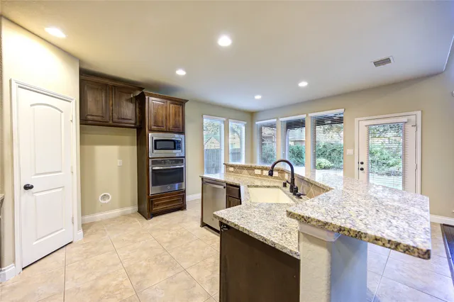 a kitchen with refrigerator and window