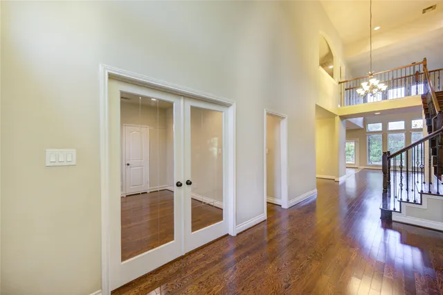 a view of a hallway with wooden floor and a living room