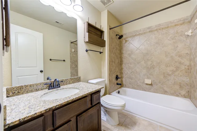 an empty room with a window and a ceiling fan