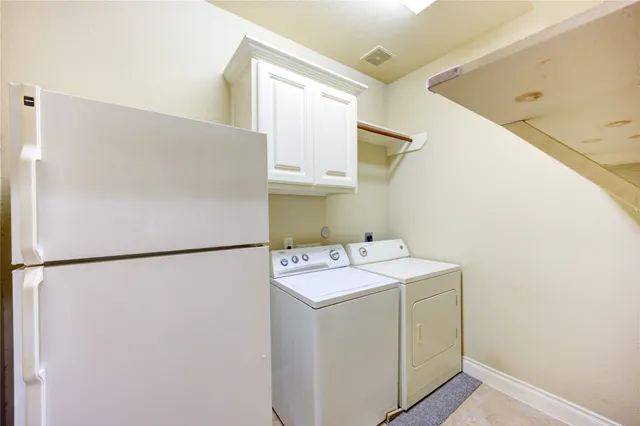 a bathroom with a granite countertop bathtub shower sink vanity mirror and toilet