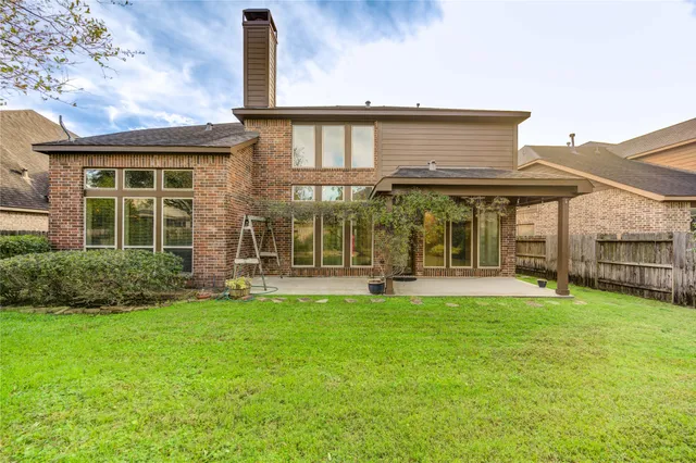 a view of a house with a yard and garden