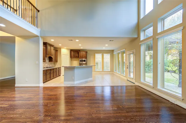 a view of a big room with wooden floor and windows