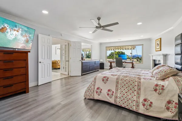 a bedroom with bed and wooden floor