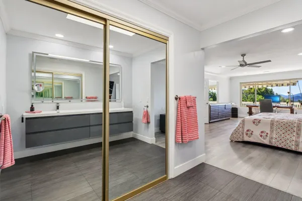 a spacious bedroom with a bed and a dresser