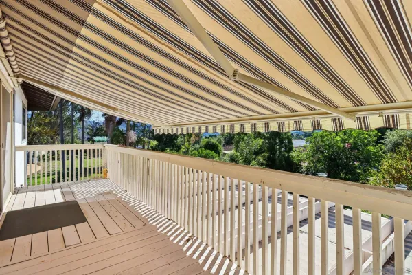 a view of balcony with wooden floor and fence