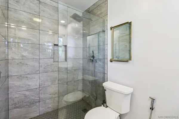 a bathroom with a toilet and shower