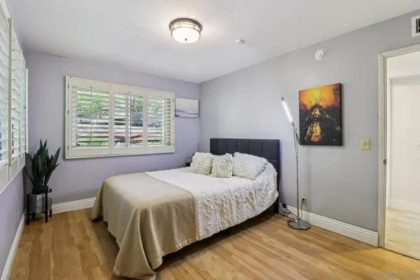 a bedroom with a large bed and a window